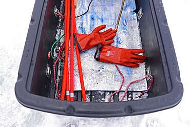 Fisherman practicing ice fishing in Lake Inari, Lapland, Finland