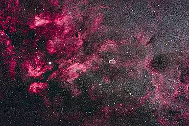 This is the central area of Cygnus and its bright Milky Way starcloud surrounded by red nebulosity. At left is the star Sadr (gamma Cygni) with the complex of nebulosity catalogued as IC 1318. At centre is the distinct Crescent Nebula, NGC 6888, a expanding nebula created by winds from a hot Wolf-Rayet star.  At bottom left is the star cluster Messier 29,  though looking a little lost in the rich starfields here. At top is the cluster IC 1311, looking more obvious than M29 but not observed visually and included in the NGC catalog. Odd. At far right are the large and loose star clusters NGC 6883 and NGC 6871, the latter an obvious binocular sight. To the left of Sadr is the small cluster NGC 6910. The dark nebulas B145 and LDN 862 are at right. The small emission nebula at bottom is Sharpless 2-104.