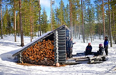 Rest and fire in a wooden refuge. Wilderness husky sledding taiga tour with Bearhillhusky in Rovaniemi, Lapland, Finland