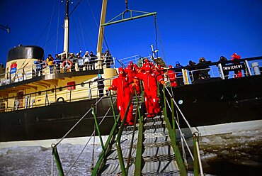 Swimming in the frozen sea during Sampo Icebreaker cruise, an authentic Finnish icebreaker turned into touristic attraction in Kemi, Lapland