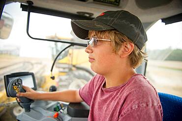 teenager in tractor cab