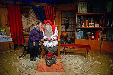 Young woman meeting Santa Claus. Official Hometown of Santa Claus in Rovaniemi, Lapland, Finland