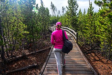 Young woman in Norris Geyser Basin, Yellowstone National Park, USA