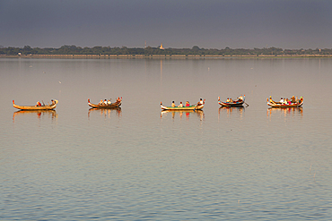 Boats transporting tourists on Taungthaman Lake, Amarapura, Mandalay, Myanmar, (Burma)