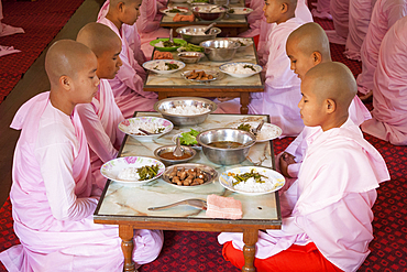 Nuns praying before eating their meals, Sakyadhita Thilashin Nunnery School, Sagaing, near Mandalay, Myanmar, (Burma)