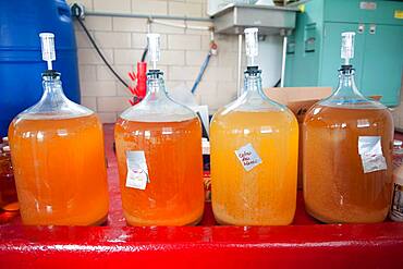 Apples, apple juice and cider press at a hard cider distillery