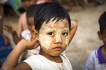 Young child wearing thanaka on his face, Yay Kyi village, Mandalay, Myanmar, (Burma)