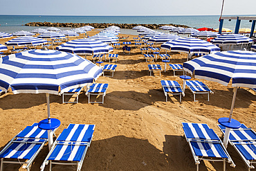 Sun umbrellas and sun beds on a beach, Marina Di Ragusa, Sicily, Italy