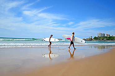 Surfers on Cote des Basques beach at sunset, Biarritz