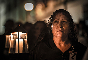 Women wearing traditional Potosi rebozos and carrying candles,