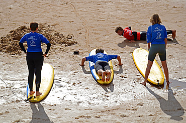 Surf lessons on Cote des Basques beach at sunset, Biarritz