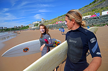 Surfers on Cote des Basques beach at sunset, Biarritz