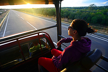 Young woman on safari jeep at Udawalawe National Park, Sri Lanka