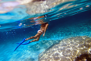 Attractive woman swimming underwater in Formentera, Balearic Islands, Spain