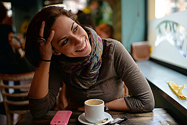 Portrait of young attractive woman in a cafe