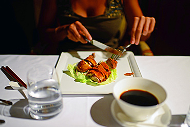 Woman eating cantonese style roasted duck in Asia Gallery Restaurant in The Westin Palace Hotel, Madrid