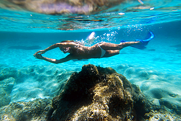 Attractive woman swimming underwater in Formentera, Balearic Islands, Spain