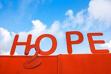 Bright red rusted sign reads "hope". Ganta Liberia