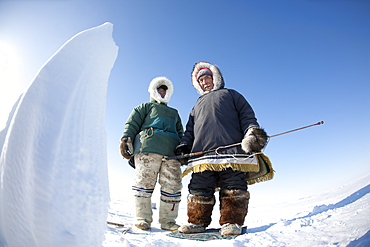 Men look for animals to hunt in Gojahaven, an Inuit settlement in the far north of Canada.