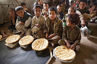 Afghan student gets food at school.