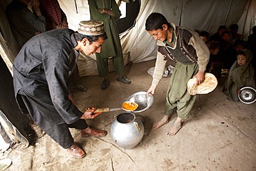 Afghan student gets food at school.