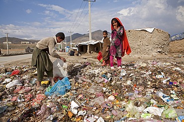 many children earn an income bt collecting plastic among rubbish, Kabul,