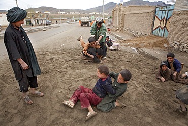 Afghan children playing in a  slum in KabulAfghan children are wrestling in kabul