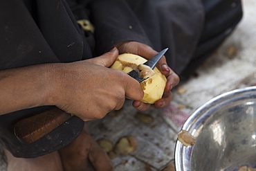 Afghan refugees preparing a potatoe meal, Afghanistan