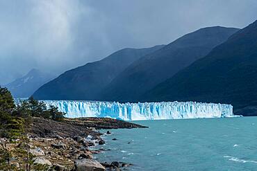 Perito Moreno Glacier and Lago Argentino in Los Glaciares National Park near El Calafate, Argentina.  A UNESCO World Heritage Site in the Patagonia region of South America.  At right is Cordon Reichert