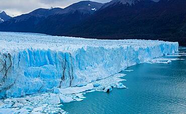 Perito Moreno Glacier and Lago Argentino in Los Glaciares National Park near El Calafate, Argentina.  A UNESCO World Heritage Site in the Patagonia region of South America.  At right is Cordon Reichert.