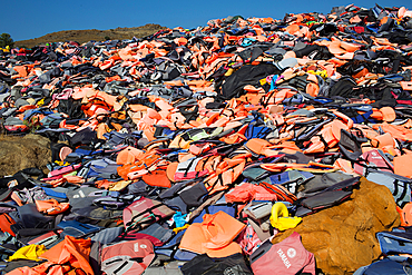 life jackets used by refugees to cross from Turkey to Greece. They are collected and dumped at the waste pit at Lesbos