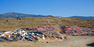 life jackets used by refugees to cross from Turkey to Greece. They are collected and dumped at the waste pit at Lesbos