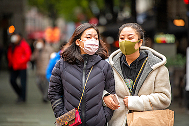 Shanghai, China, 27th Jan 2020, Two women wearing masks walk together in Xintiandi district