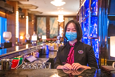 Shanghai, China, 27th Jan 2020, A bartender wearing a mask behind the bar at Ritz Carlton