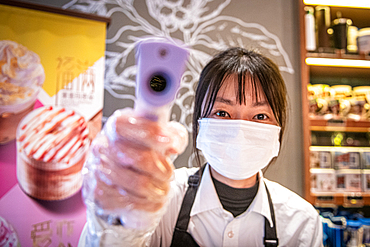 Shanghai, China, 28th Jan 2020, Starbucks worker in China checking temperatures of patrons to assure biosecurity from the Coronavirus