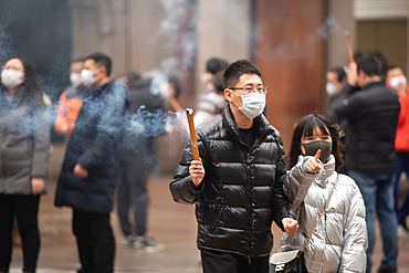 Shanghai, China, 23rd Jan 2020, People wearing masks and burning joss sticks to prevent catching the coronavirus