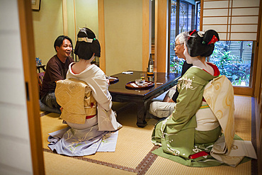 Fukuyu,geisha and Fukukimi,'maiko' (geisha apprentice) workimg in Miyaki tea house (o-chaia).Geisha's distric of Miyagawacho.Kyoto. Kansai, Japan.