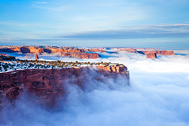 Above the clouds of a winter temperature inversion in Canyonlands National Park, Moab, Utah. Viewed from Buck Canyon Overlook, Island in the Sky District.