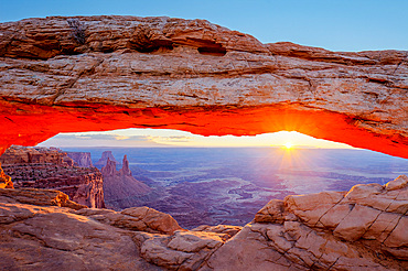 Mesa Arch at sunrise with the Washer Woman Arch, Monster Tower & Airport Tower. Canyonlands National Park, Utah.