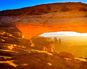 Mesa Arch at sunrise with the Washer Woman Arch, Monster Tower & Airport Tower. Canyonlands National Park, Utah.