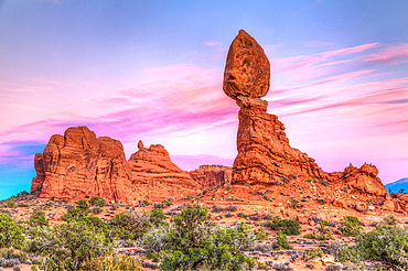 Tourists around Balanced Rock in Arches National Park, Moab, Utah.