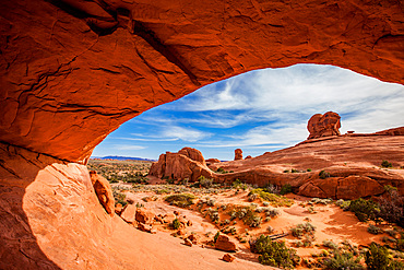 Orange glow from reflected light on the underside of Eye of the Whale Arch in Arches National Park, Moab, Utah.