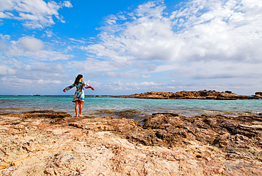 Young attractive brunette breathing on the beach in Formentera, Balearic Islands, Spain