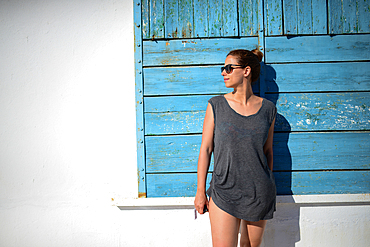 Young attractive woman standing by a wall at summer in Mallorca, Spain