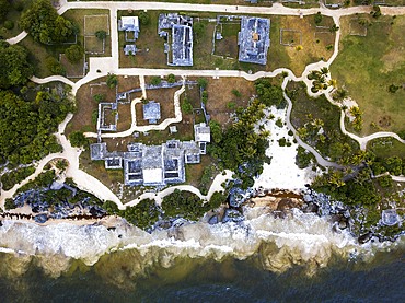 Aerial views of El Castillo and the Ruins of the Mayan temple grounds at Tulum, Quintana Roo, Yucatan, Mexico. Tulum is the site of a pre-Columbian Mayan walled city which served as a major port for Coba, in the Mexican state of Quintana Roo. The ruins are situated on 12 meter 39 ft tall cliffs along the east coast of the Yucatán Peninsula on the Caribbean Sea in the state of Quintana Roo, Mexico. Tulum was one of the last cities built and inhabited by the Maya; it was at its height between the 13th and 15th centuries and managed to survive about 70 years after the Spanish began occupying Mexico. Old World diseases brought by the Spanish settlers appear to have resulted in very high fatalities, disrupting the society, and eventually causing the city to be abandoned.