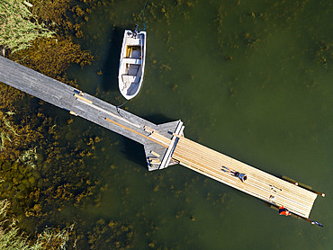 Aerial view of small dock in Korpo or Korppoo island, Korpostrom coast Southwest Finland Turku archipelago. The archipelago ring road or Saariston rengastie is full of things to see, do and do. The Archipelago Trail can be taken clockwise or counter clockwise, starting in the historical city of Turku, and continuing through rural archipelago villages and astonishing Baltic Sea sceneries. The Trail can be taken from the beginning of June until the end of August.