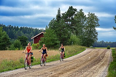 Riding a bicycle in Nagu or Nauvo island in Väståboland in Pargas in Southwest Finland Turku archipelago. The archipelago ring road or Saariston rengastie is full of things to see, do and do. The Archipelago Trail can be taken clockwise or counter clockwise, starting in the historical city of Turku, and continuing through rural archipelago villages and astonishing Baltic Sea sceneries. The Trail can be taken from the beginning of June until the end of August.