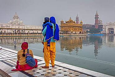 pilgrims and sacred pool Amrit Sarovar, Golden temple, Amritsar, Punjab, India