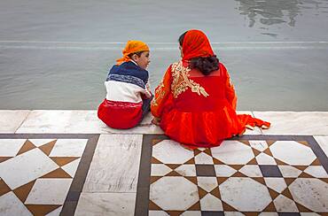 pilgrims and sacred pool Amrit Sarovar, Golden temple, Amritsar, Punjab, India