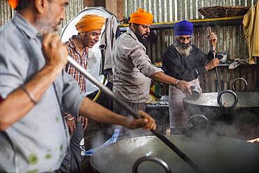 Volunteers cooking for the pilgrims who visit the Golden Temple, Each day they serve free food for 60,000 - 80,000 pilgrims, Golden temple, Amritsar, Punjab, India